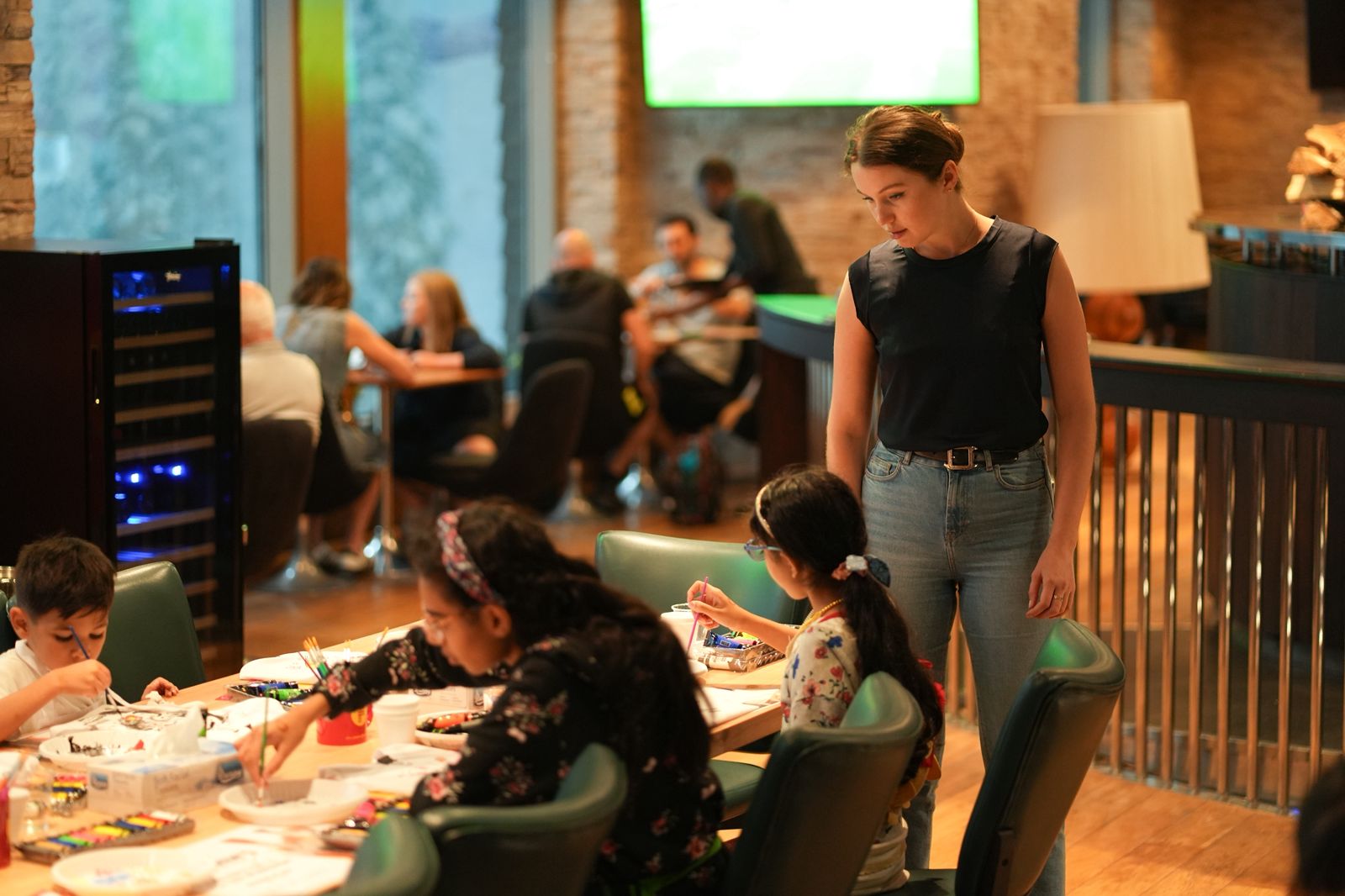 Child focused on painting during at-home art session in Dubai