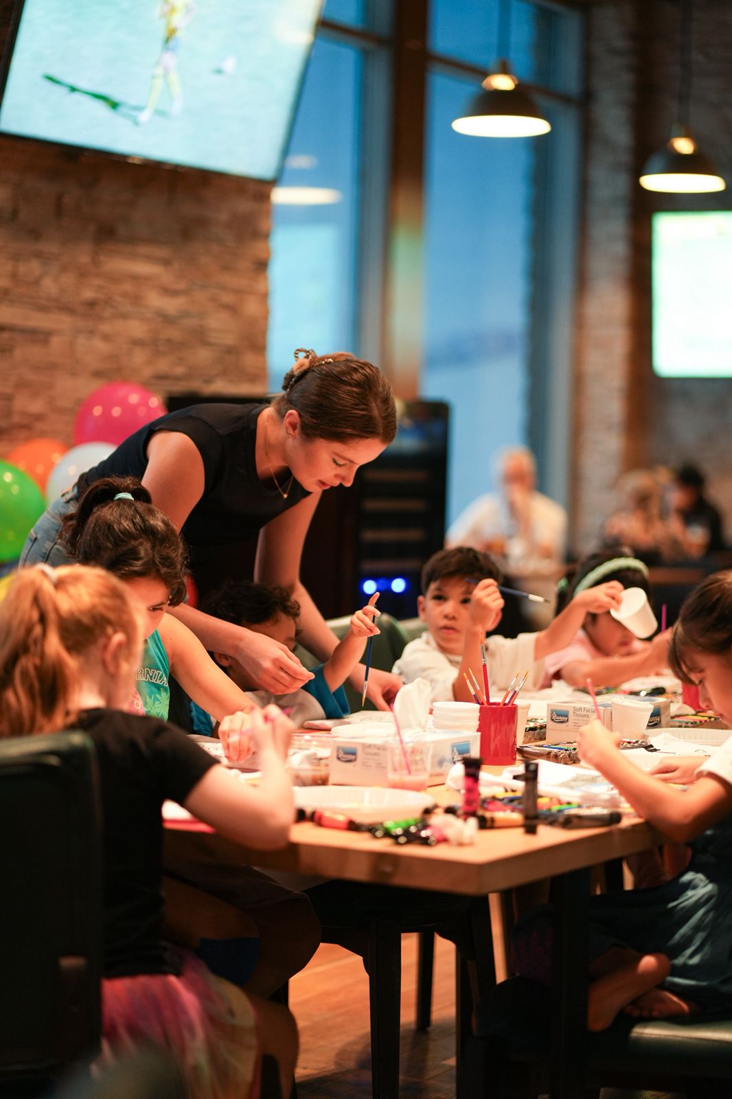 Child painting watercolors at home during art session in Dubai
