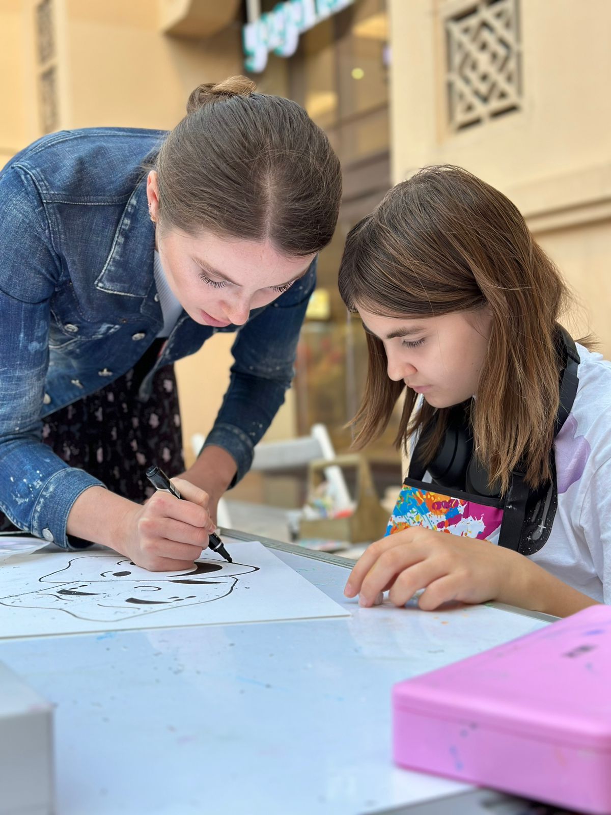 Art instructor Inga teaching child painting in Dubai home